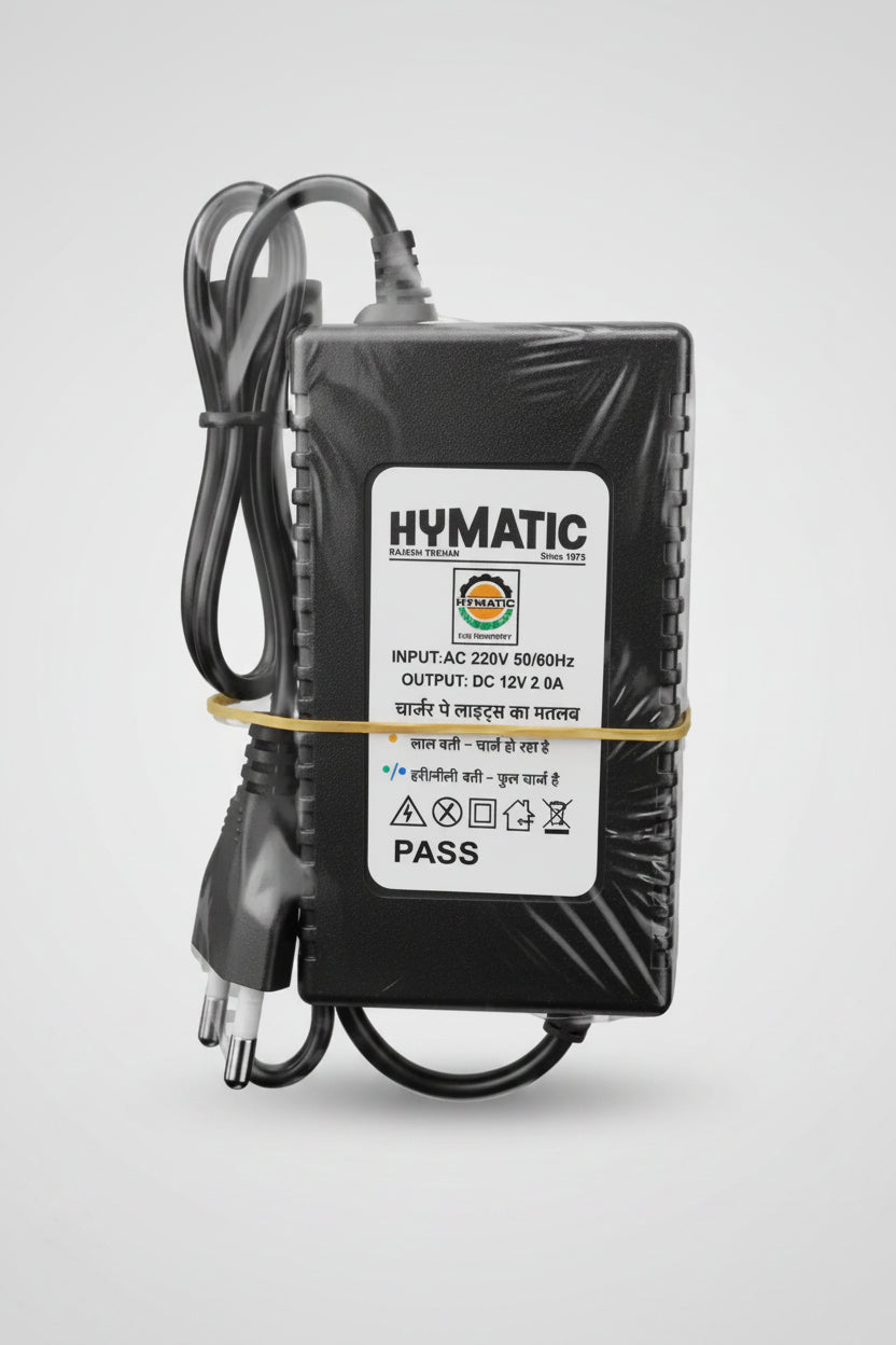 Hymatic mains power adapter with cord, label reads input 220V AC, output DC 12V 2A, bundled with a rubber band.