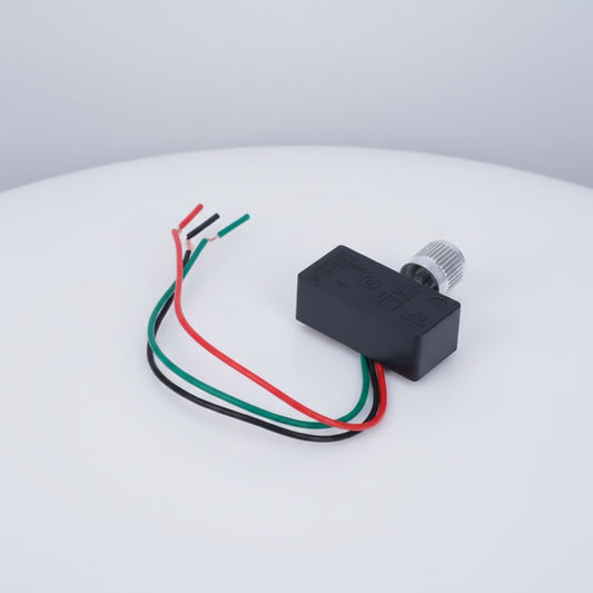 A small black electronic module with a silver threaded connector and three wires in red, green, and black, shown on a plain white background.
